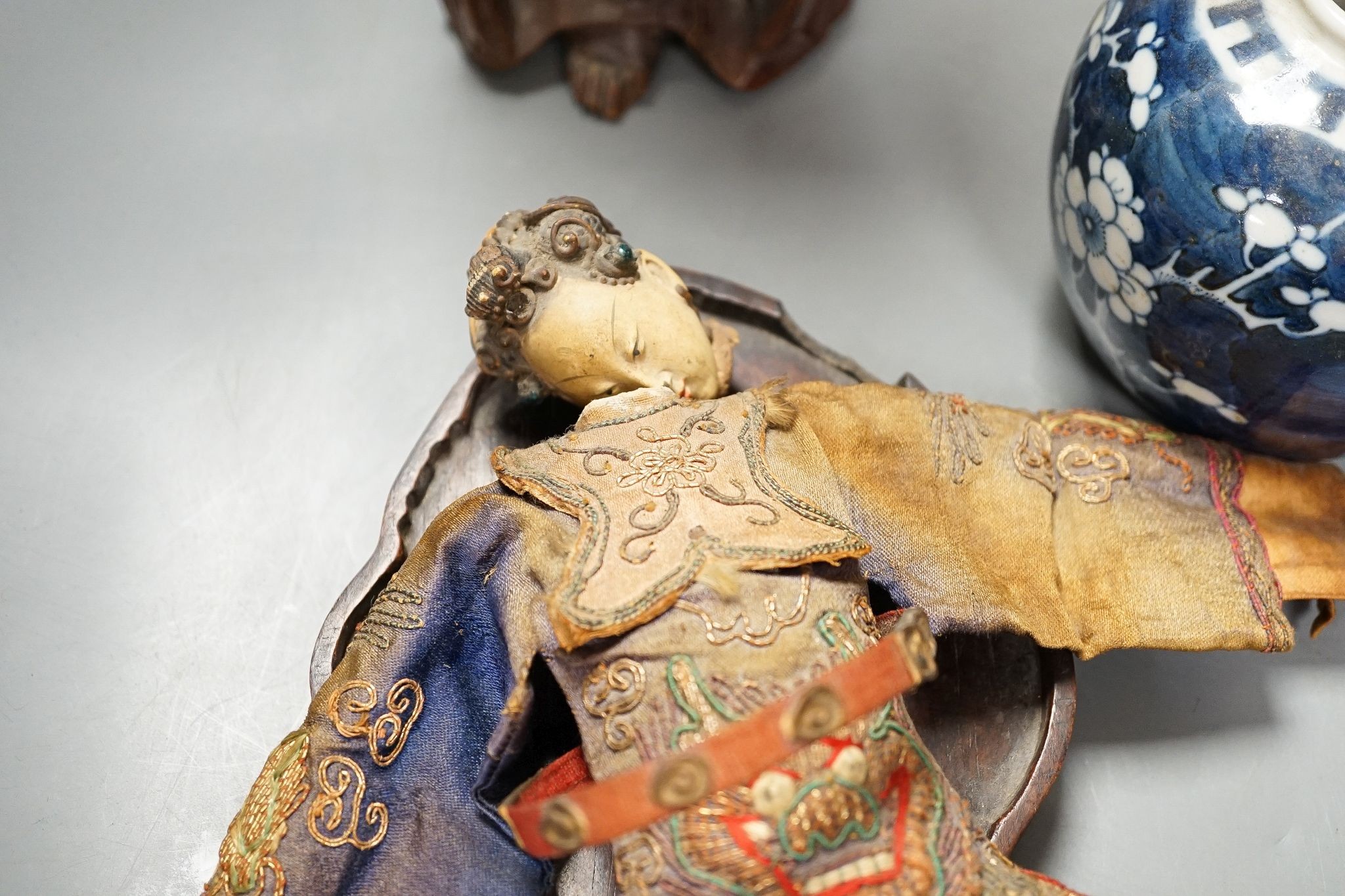 A Chinese carving of a deity, 32cm, a prunus jar, miniature vase, etc.